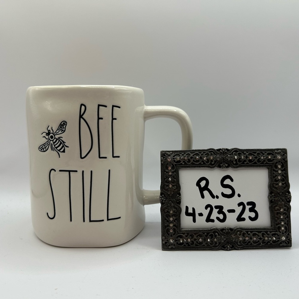 Rae Dunn 🐝”Bee Still” mug with yellow inside.